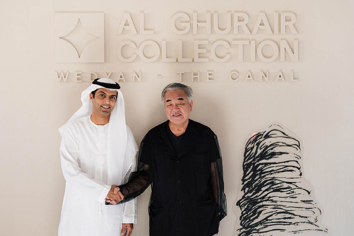 Handshake in front of the Al Ghurair Collection Wedyan sign